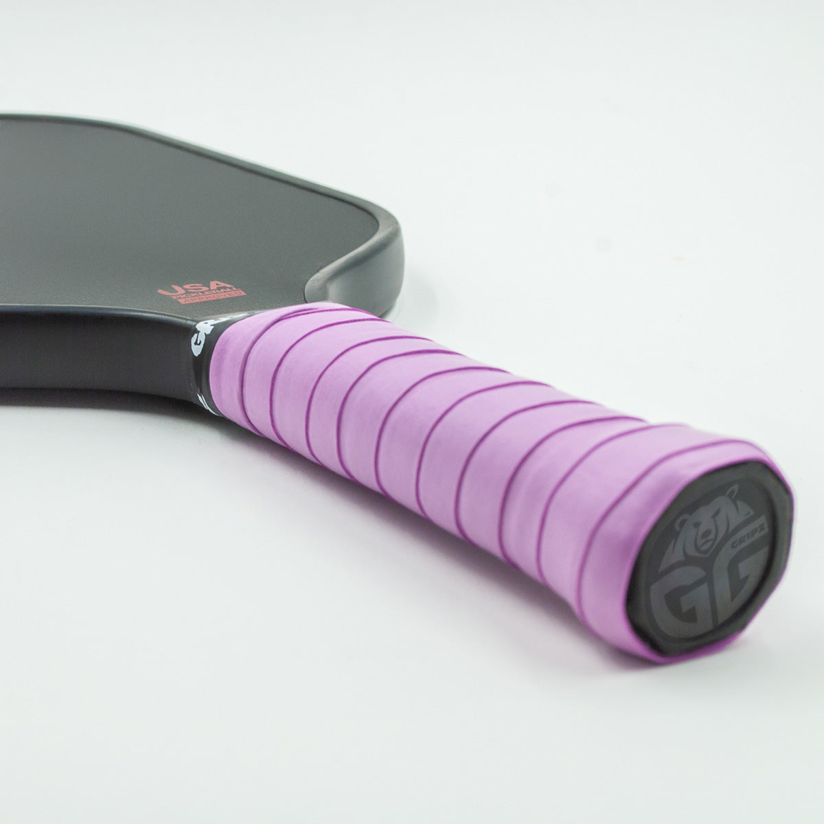 Light purple Grizzlee Gripz wrapped around a paddle handle, quality pickleball grips you can trust in performance on the court
