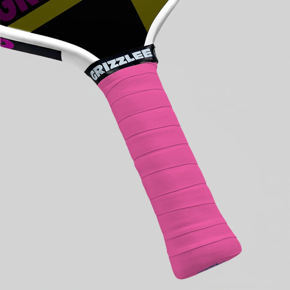 Pink pickleball paddle grip with 'Grizzlee' branding on a gray background