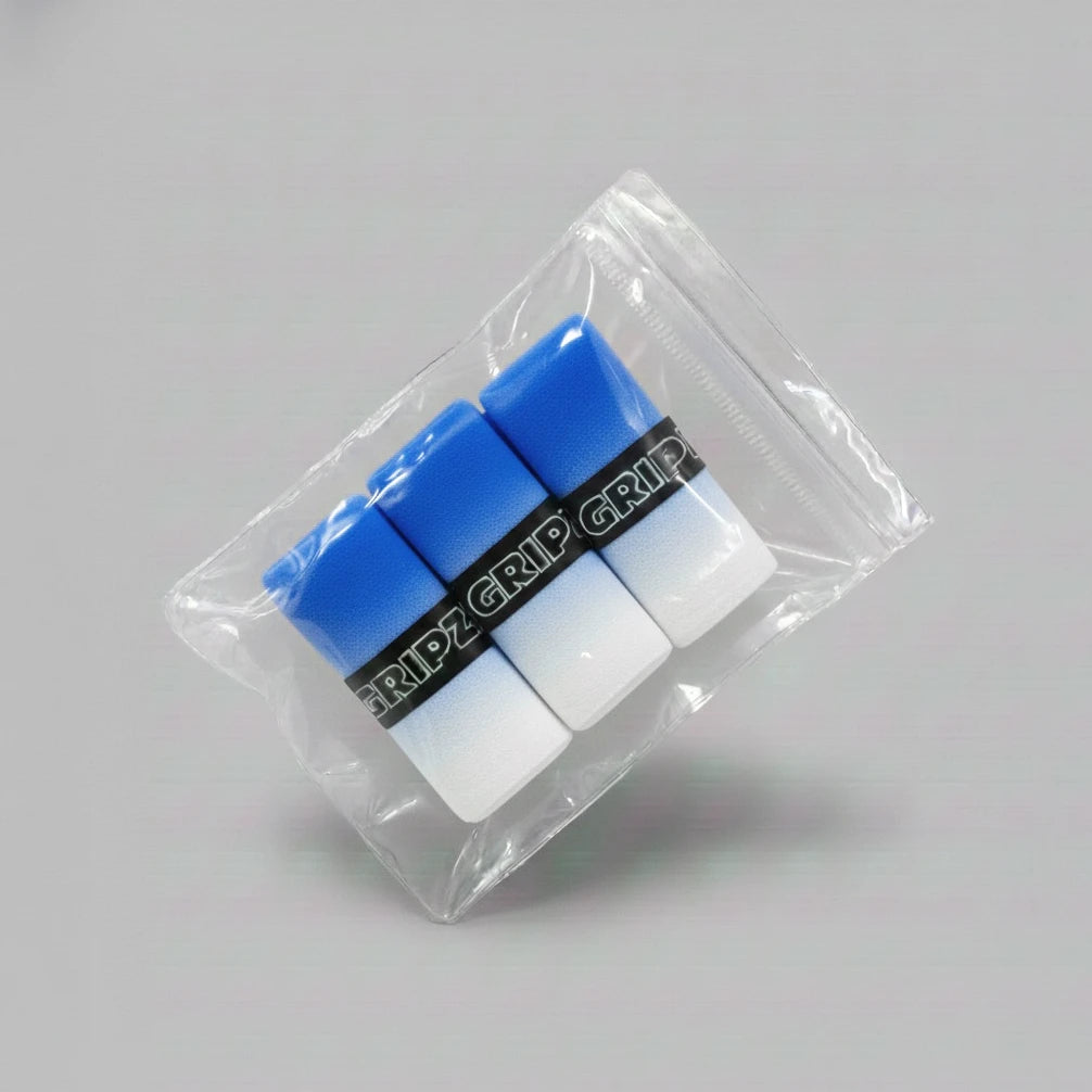 Grizzlee Gripz Packaged blue and white pickleball and tennis overgrips on a gray background